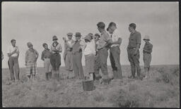 Postcard of a photograph of Edgar Hewett speaking to a group of students in the field, sent from Ralph V.D. Magoffin to Edgar Hewett